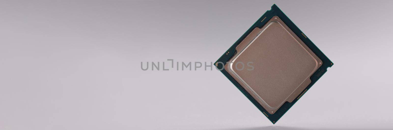 Tiny central processing unit, processor chip on grey background by kuprevich