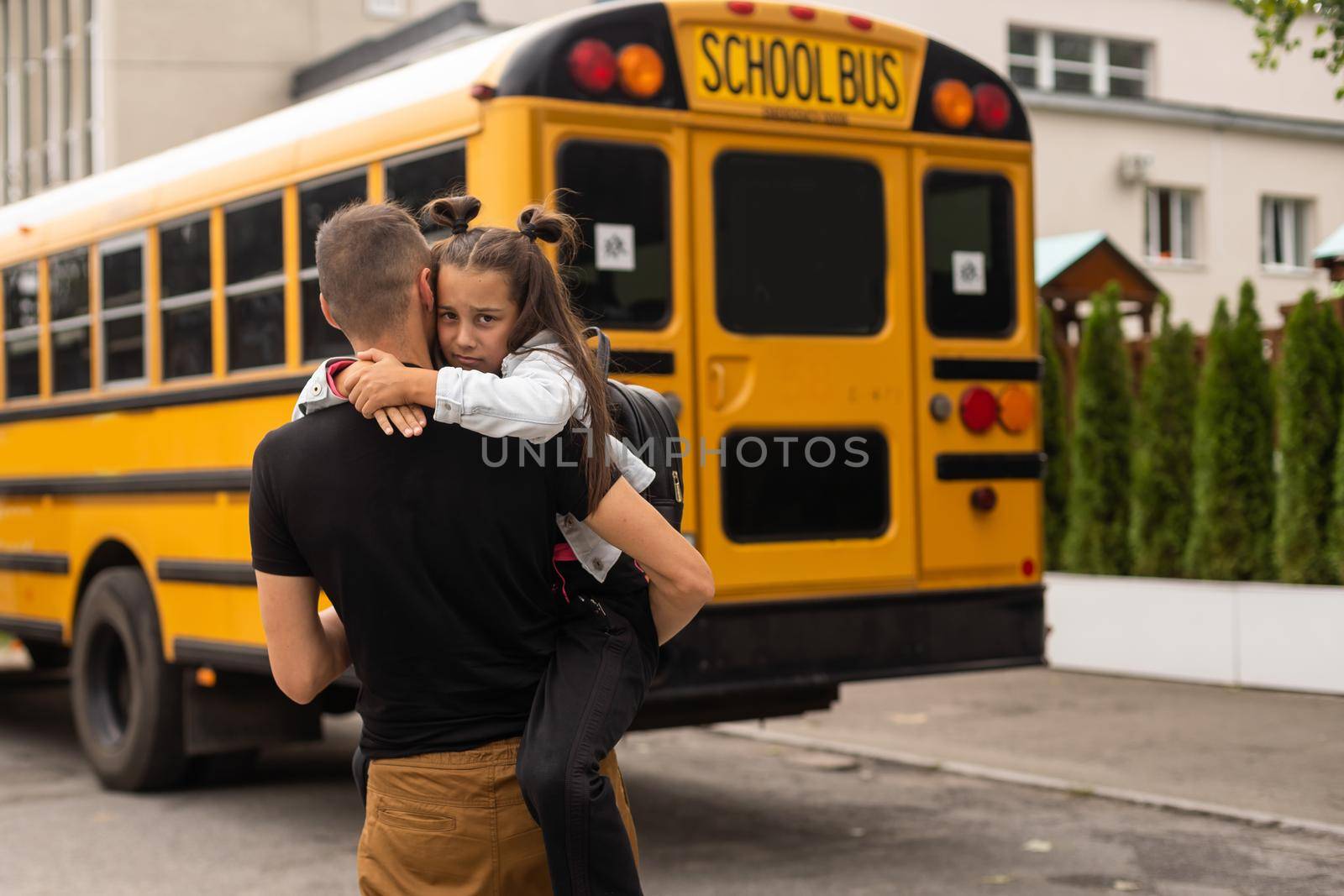 Parent taking child to school. Pupil of primary school go study with backpack outdoors. Father and son go hand in hand. Beginning of lessons. Back to school. First day of fall. Elementary student.