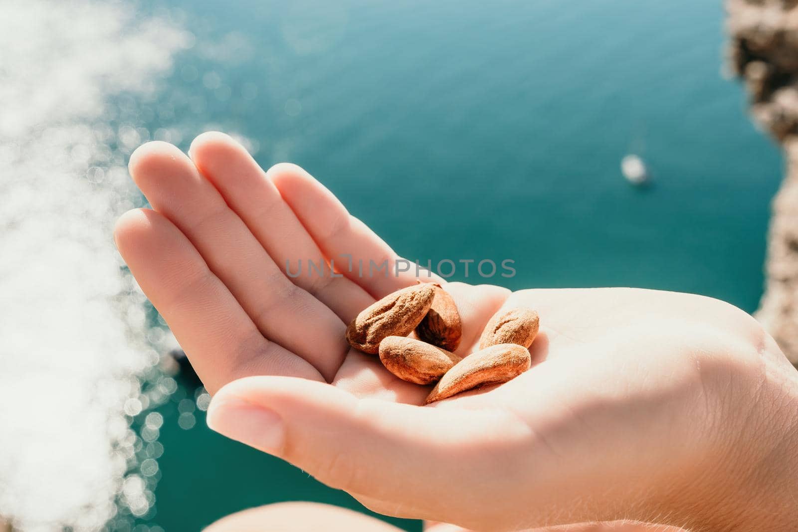 Unrecognizable caucasian woman eating young milky almond nuts. Healthy vegan food