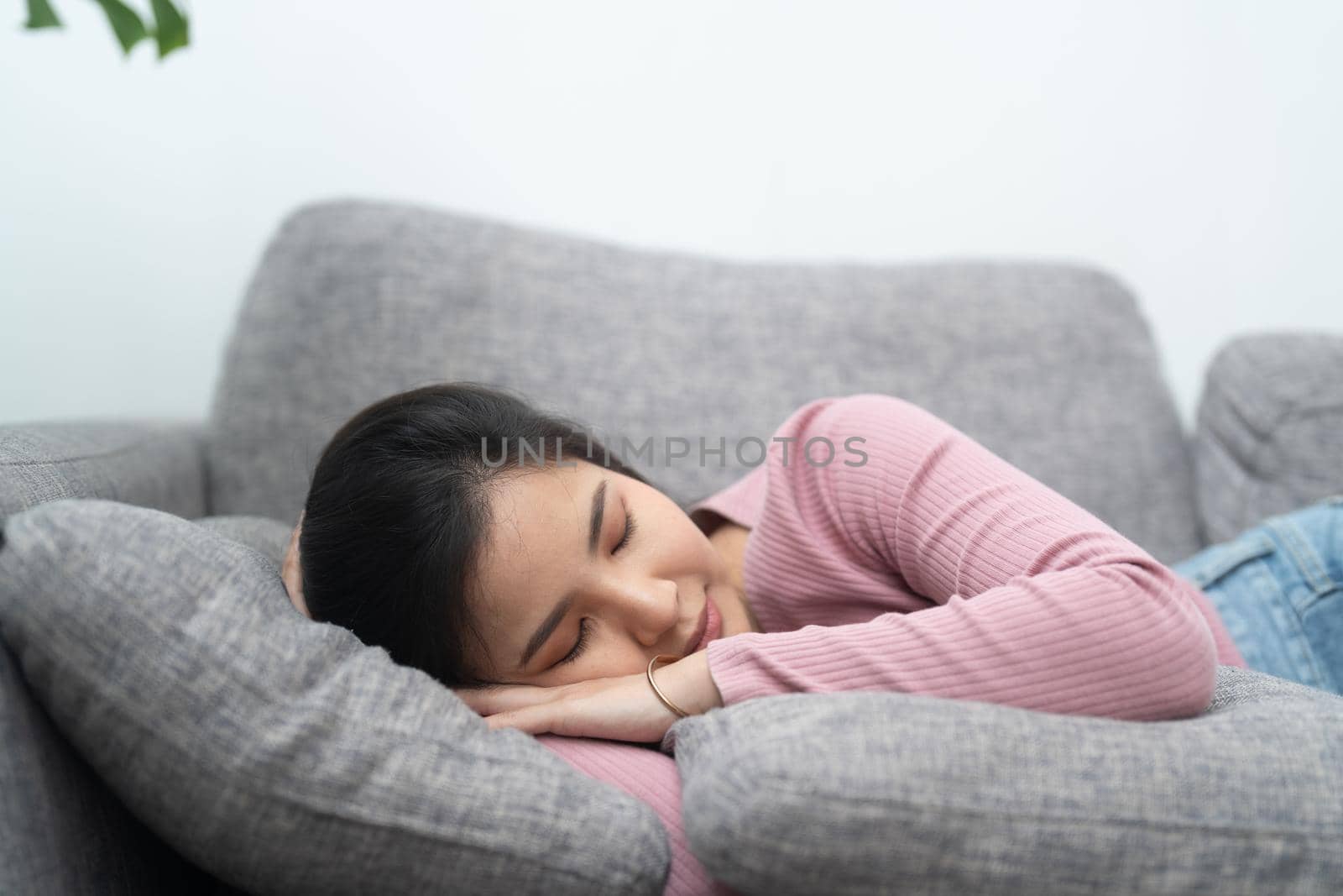 Young asian woman sleeping on sofa at home.