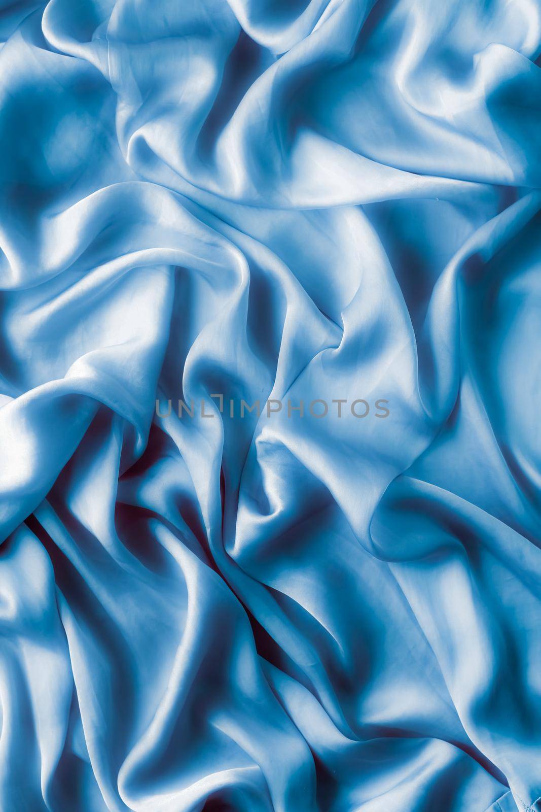Blue soft silk waves, flatlay - elegant fabric textures, abstract backgrounds and modern pastel colours concept. Feel the touch of luxury