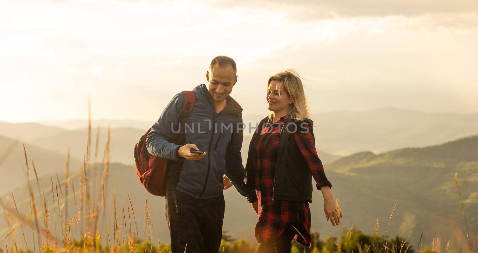 beautiful young couple enjoying nature at mountain by Andelov13