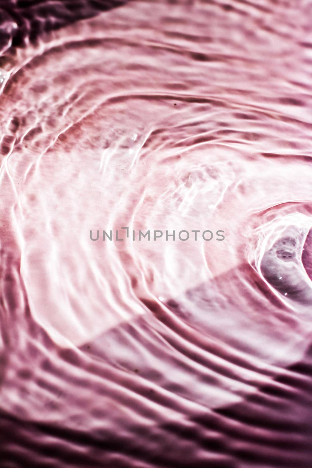 Pink flowing water texture as an abstract background - colourful liquids and creative designs concept. Pink flow