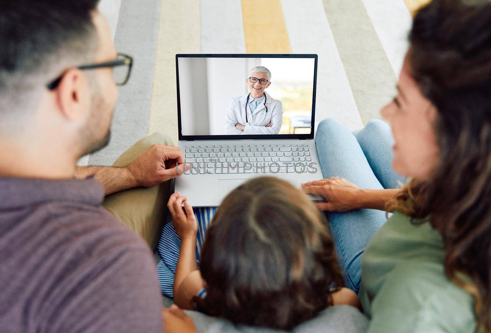 Back view of family making video call with their doctor while staying at home