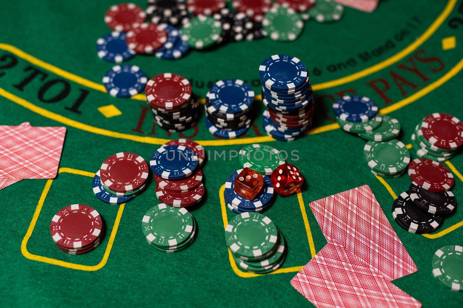 cards on a green cloth Casino table.