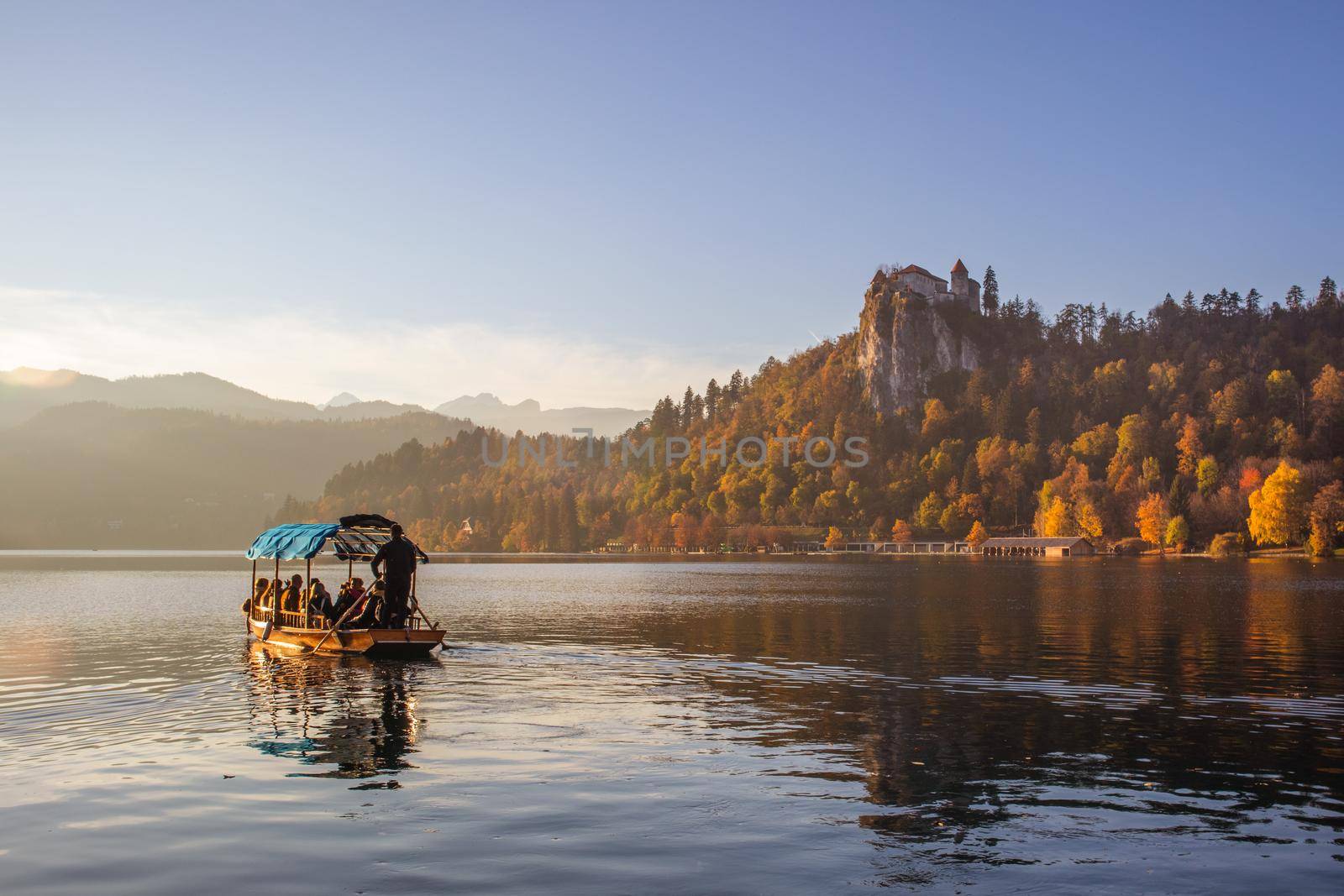 Traditional wooden boat on picture perfect picturesque lake Bled, Slovenia at sunset.