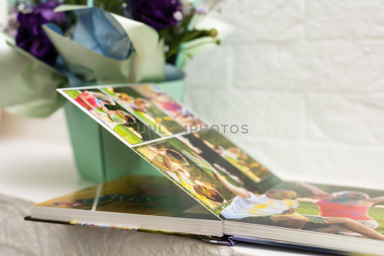 purple bouquet on the photobook on a light background.