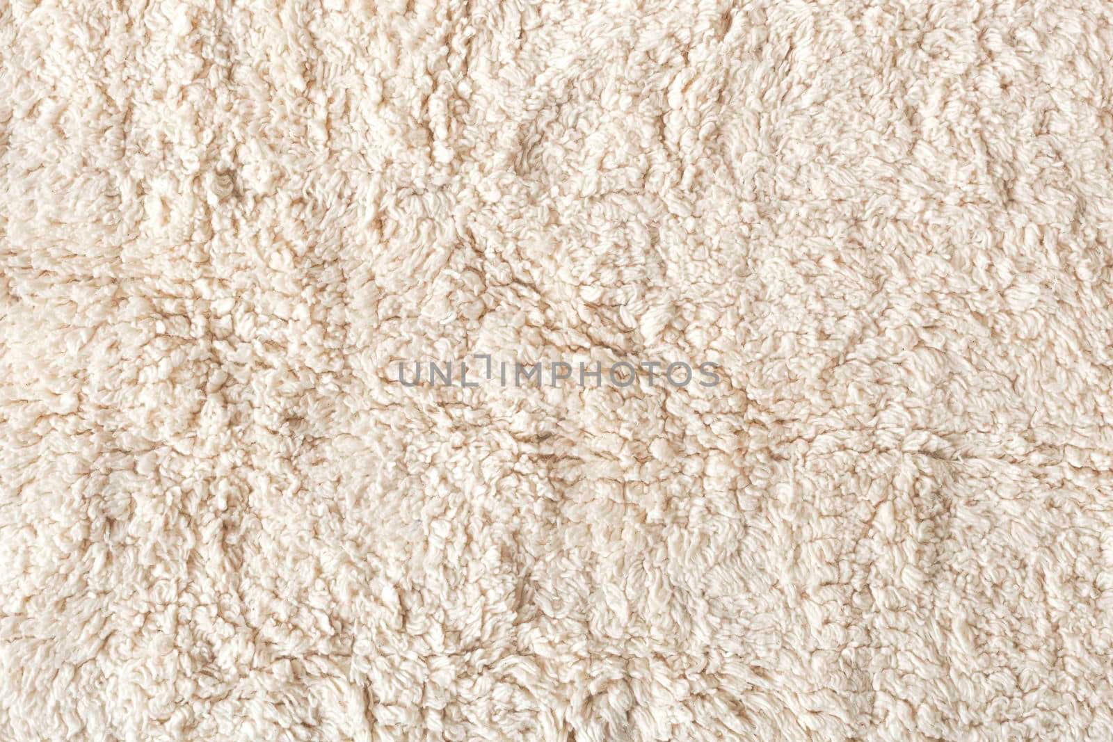 beige soft ecological fur textile background, flatlay