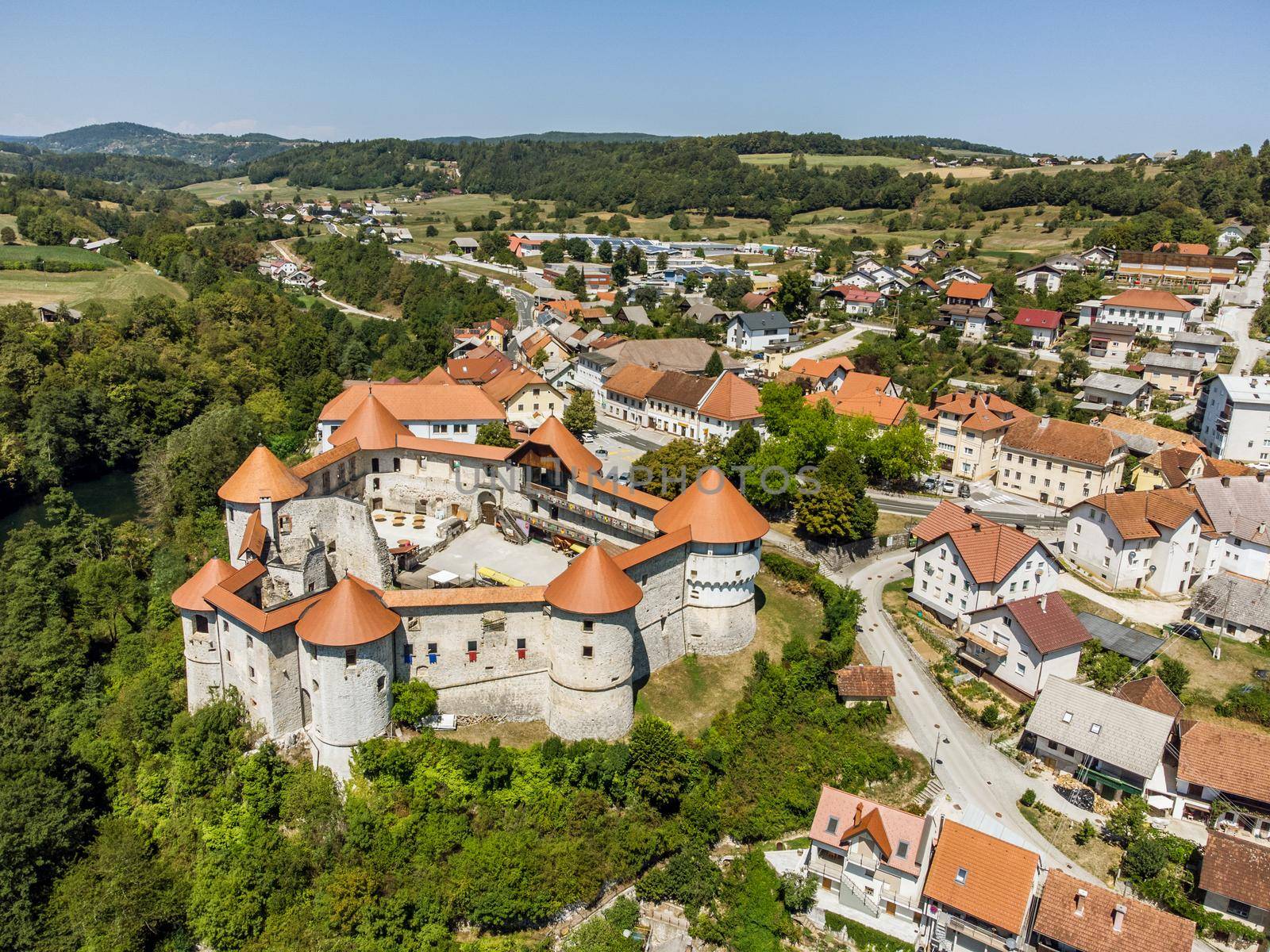 Aerial drone view of Medieval castle of Zuzemberk or Seisenburg or Sosenberch, positioned on terrace above the Krka River Canyon, Central Slovenia