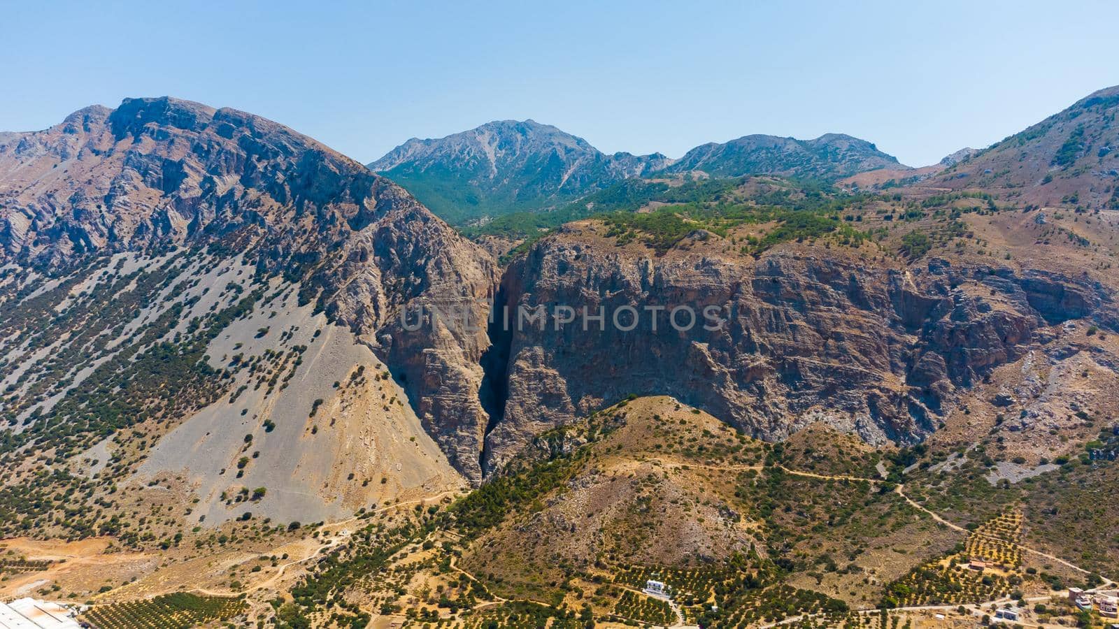 Landscape of high hills in Crete on the background of the sky.