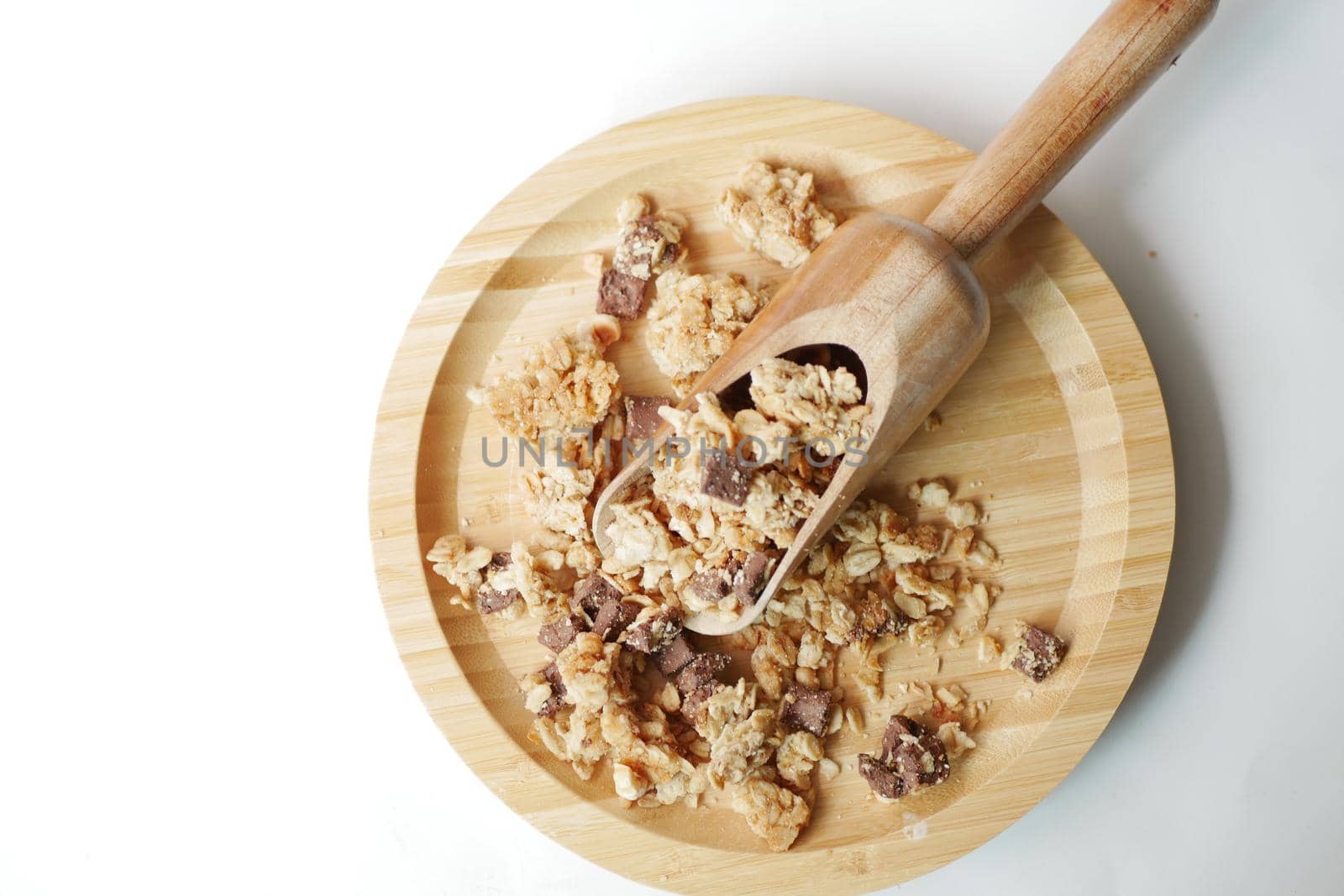 top view of granola Musli on wooden board on white .