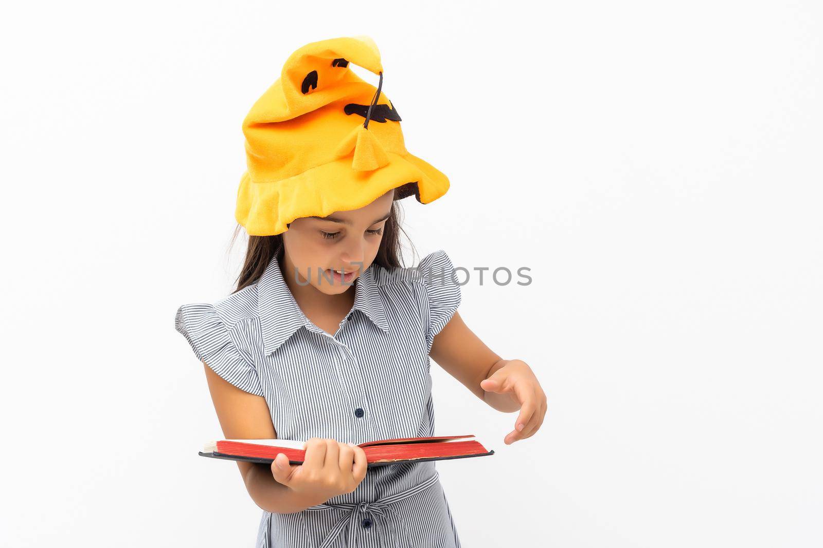 little girl in a witch hat on a white background.