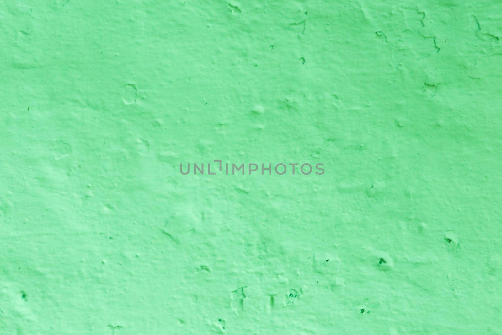 Green Textured Wall Background. The surface of the old plaster of green bright color.