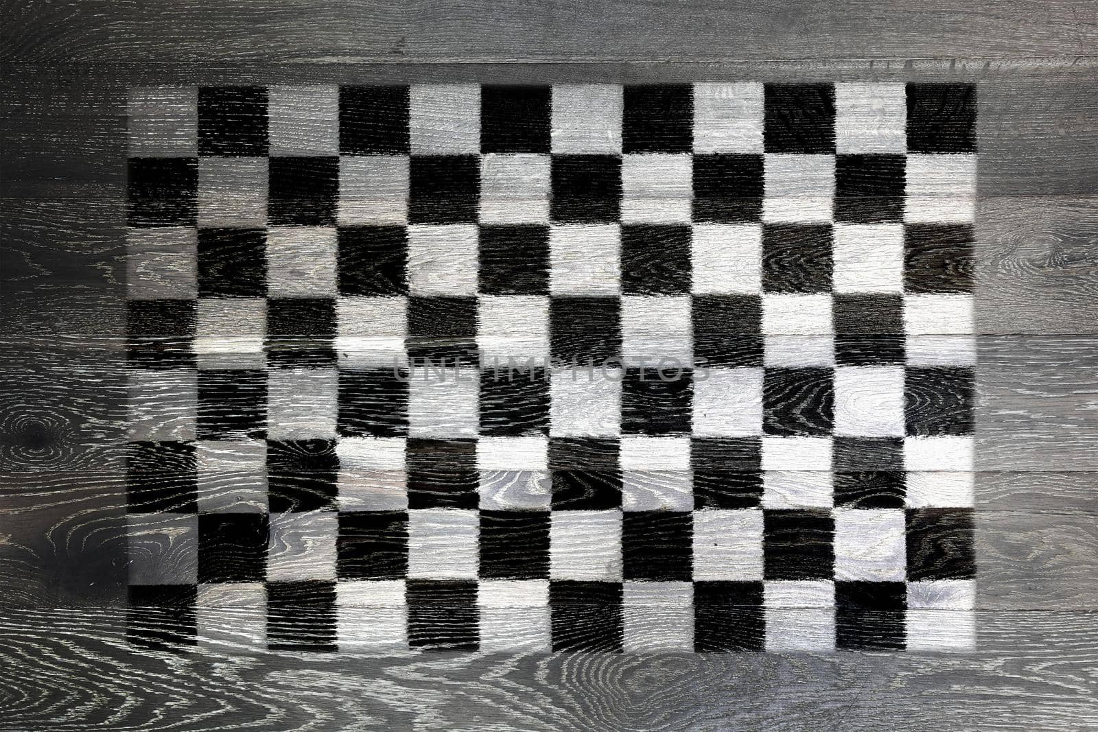 A Chequered flag on rustic old wood surface background