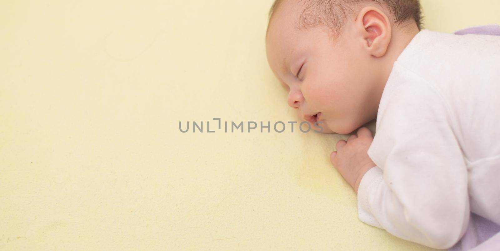 The baby sleeps in the copy space crib . Advertising of children's goods. Illustrating children's articles. A small child. A newborn. A child's dream.