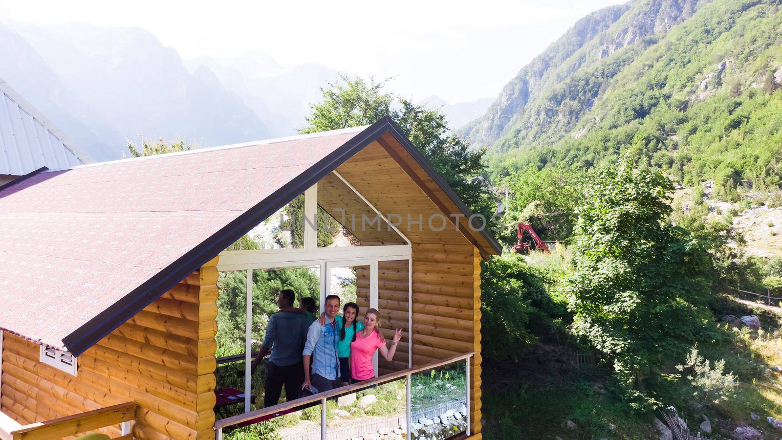 Cheerful family on terrace of mountain house together by Andelov13