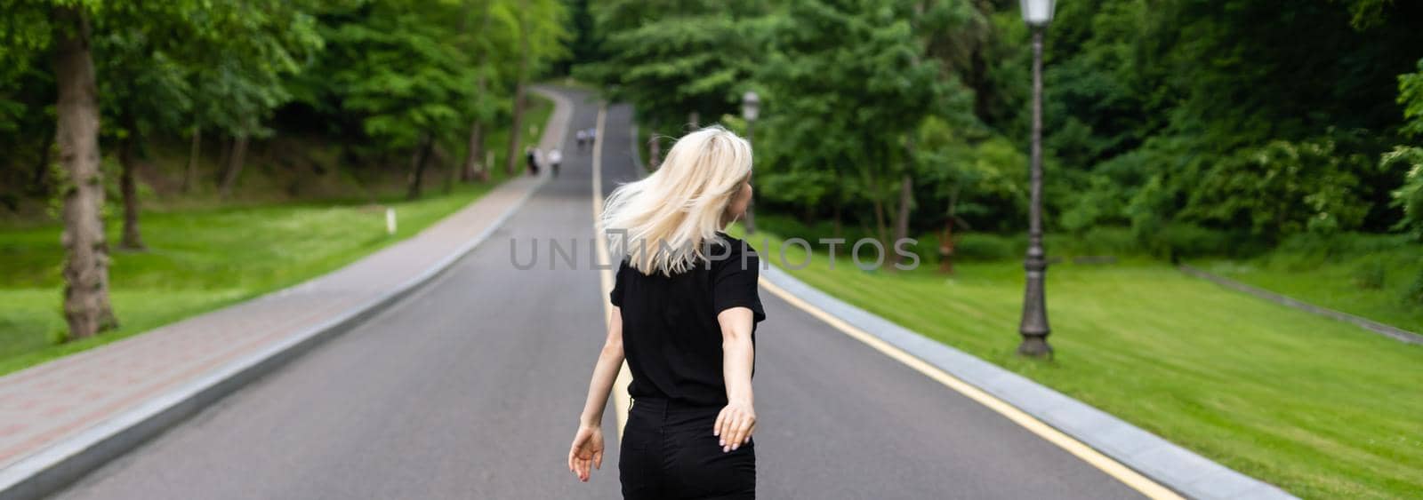 Woman walking along a country road by Andelov13