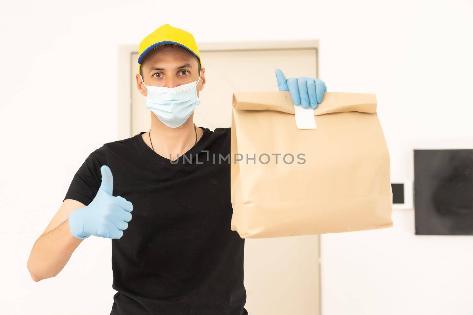 delivery man in protective gloves and a mask by Andelov13