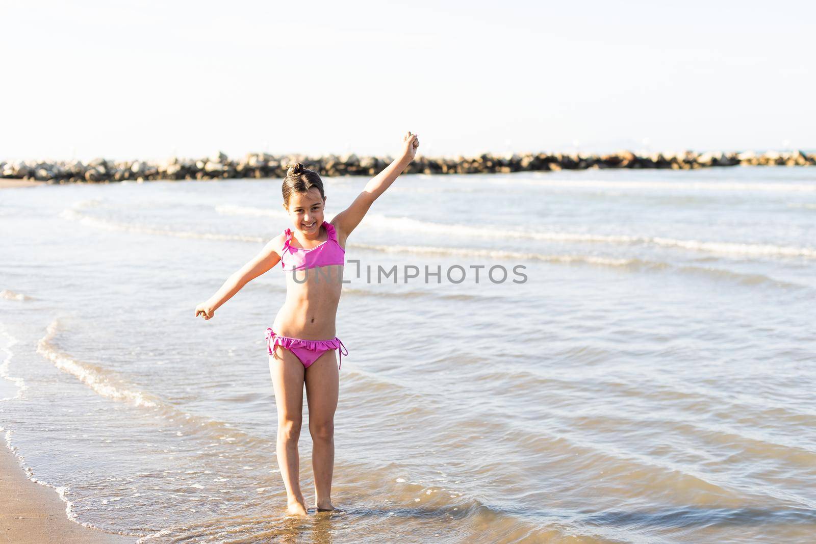 Portrait of a happy little girl against the backdrop of a tropical landscape. Summer vacations concept by Andelov13