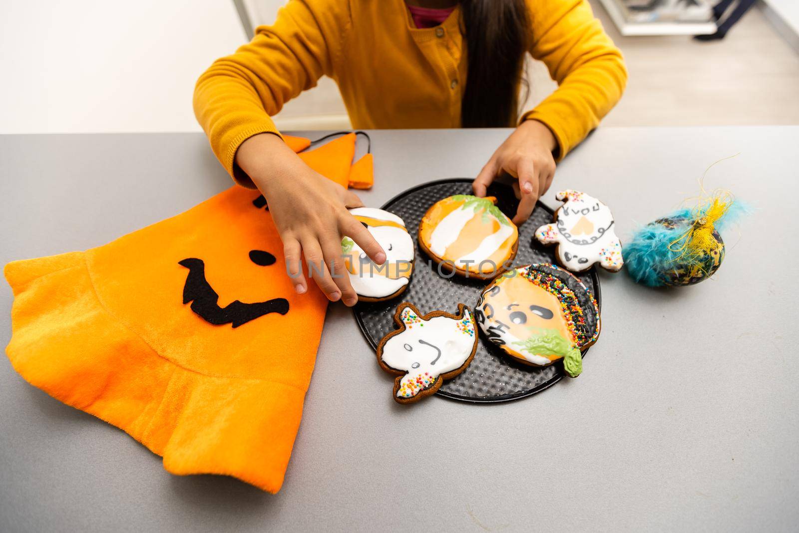 Master class for children on baking funny halloween cookies. Young children learn to cook a funny monster cookies. Kids preparing homemade cookies. Little cook