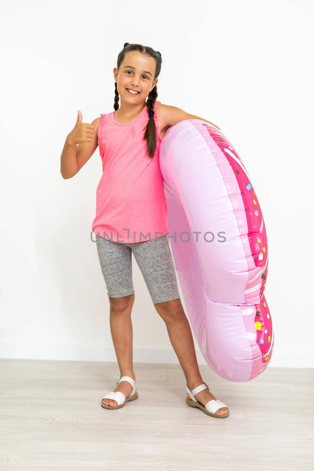 Caucasian girl with big pink rubber ring.