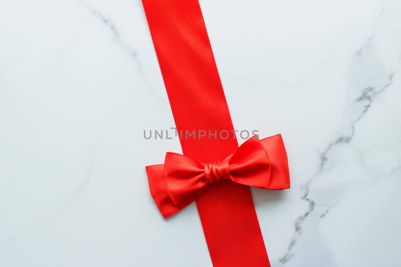 Holiday decor, feminine design and flatlay concept - Red silk ribbon on marble, top view