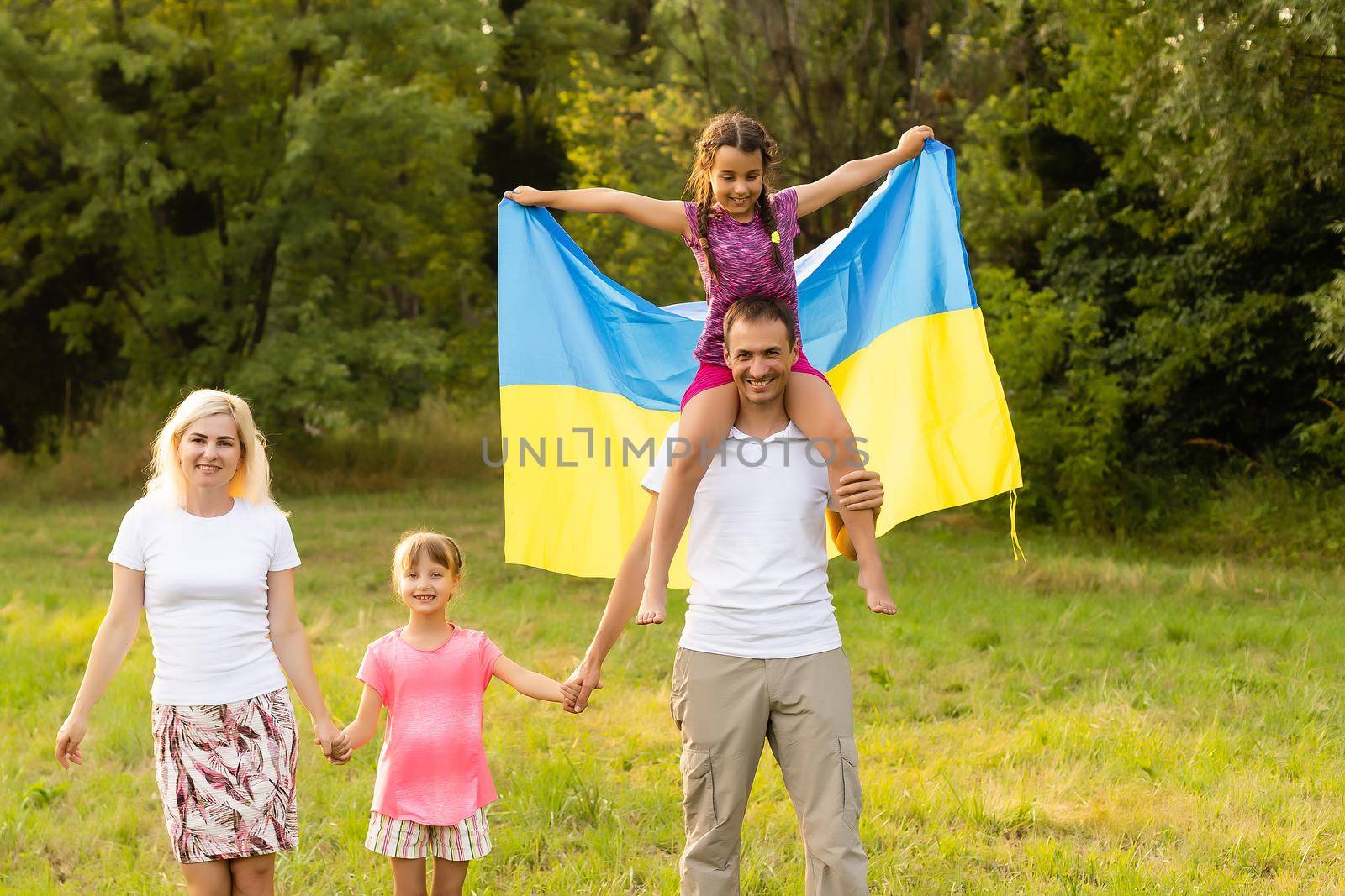 Ukraine's Independence Flag Day. Constitution day. family with the flag of ukraine in field. 24 August. Patriotic holiday