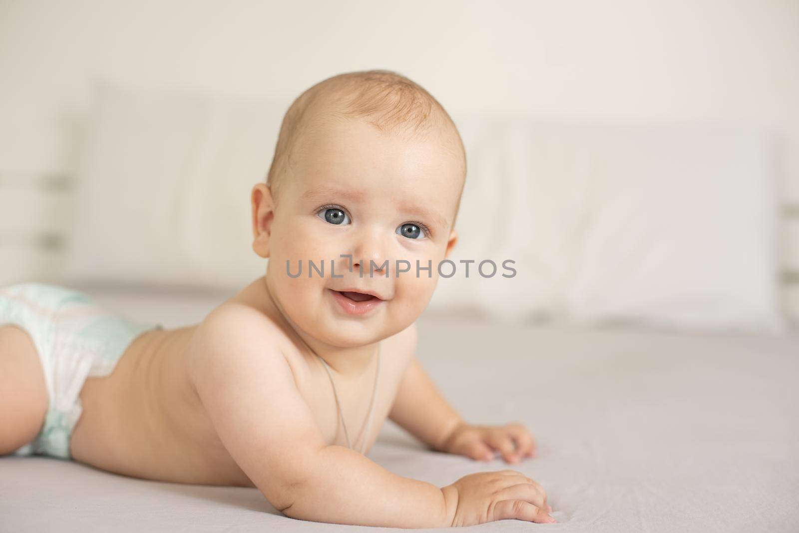 Portrait of a crawling baby on the bed in her room by Andelov13