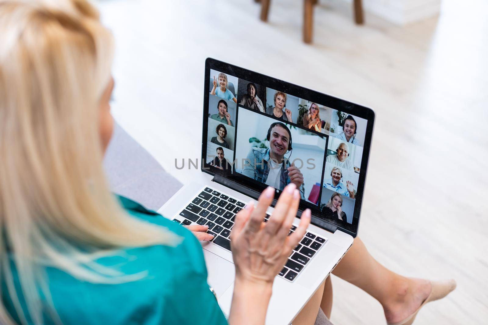 Woman having video chat with colleagues at table in office, closeup.