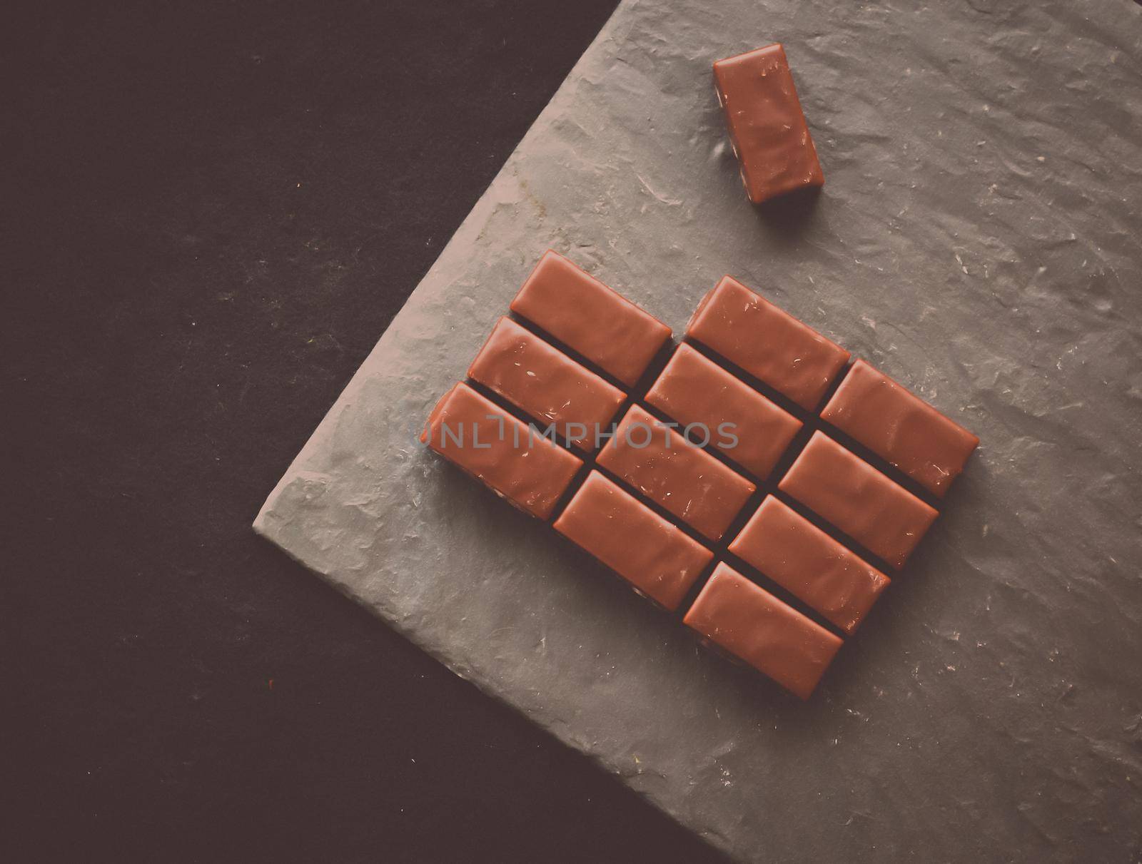 Sweet swiss chocolate candies on a stone tabletop, flatlay - desserts, confectionery and gluten-free organic food concept. All you need is chocolate