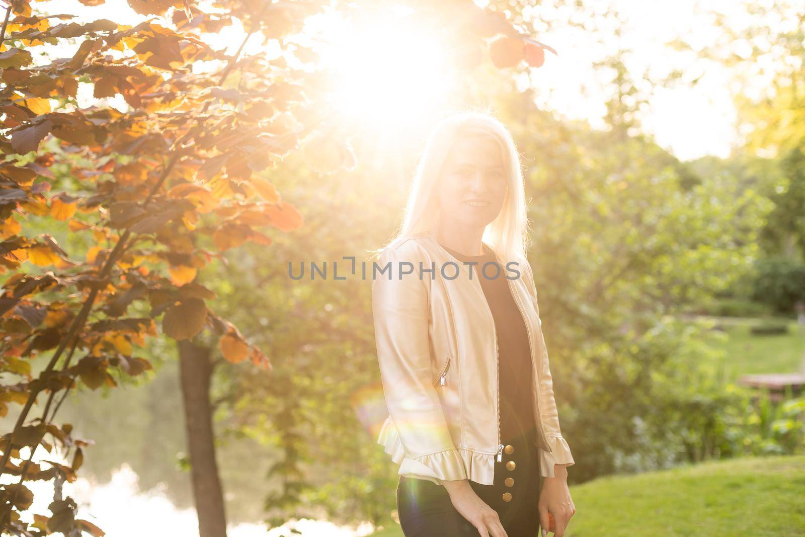 Thoughtful woman alone outdoors in an urban park by Andelov13