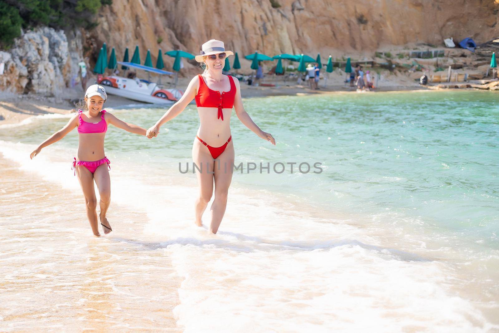 Mother with little daughter on the beach by Andelov13