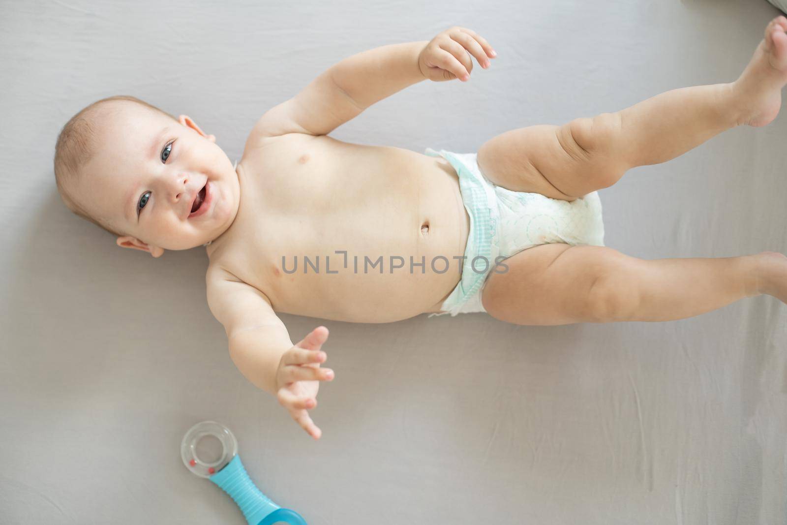 Portrait of a crawling baby on the bed in her room.