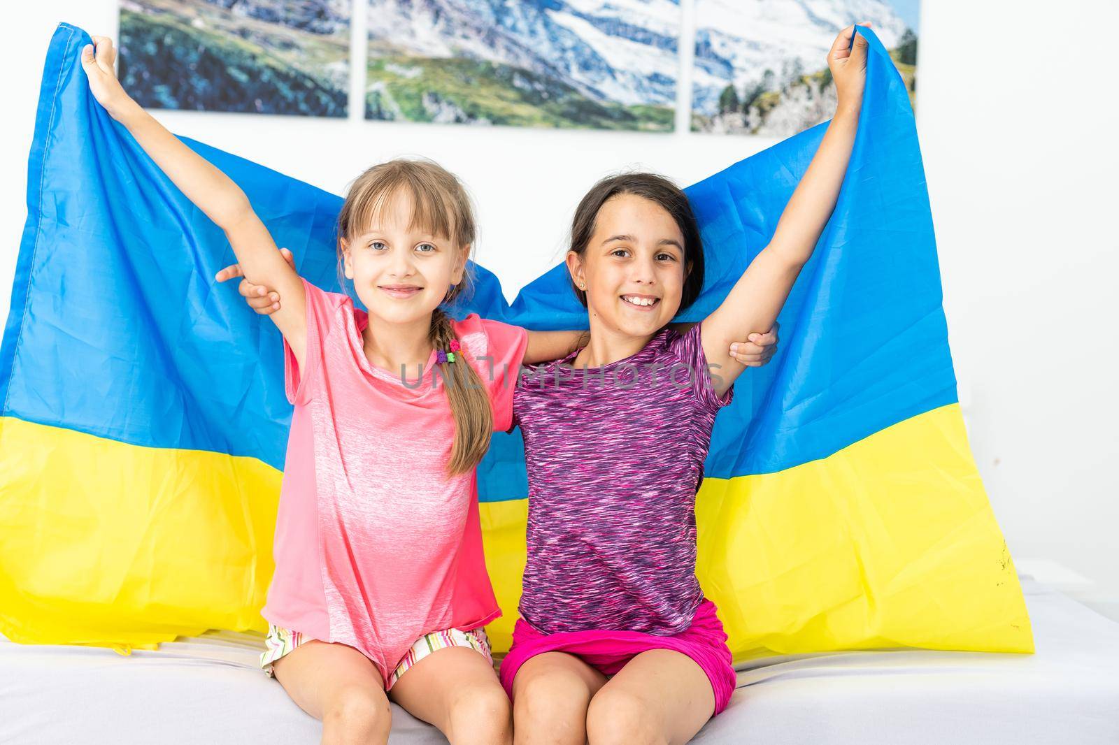 two little girls with the flag of ukraine