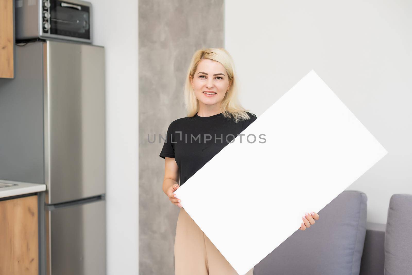 woman holding a blank board for your text by Andelov13