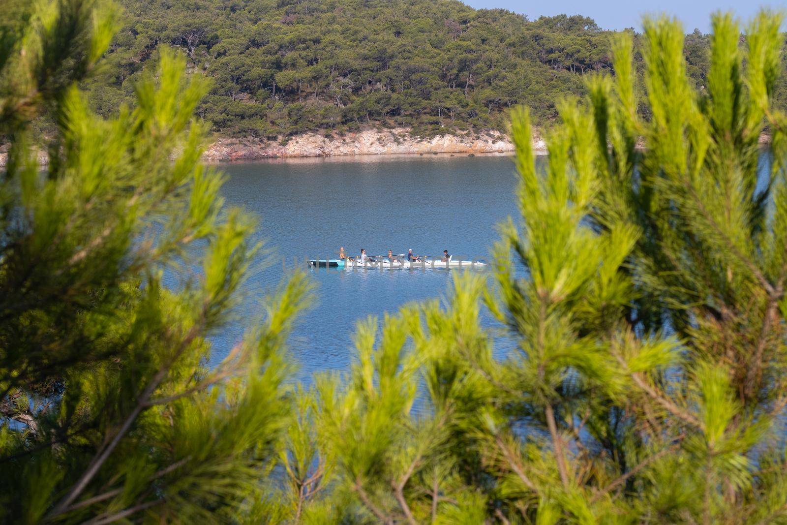rowing team paddles on the tranquil sea. High quality photo