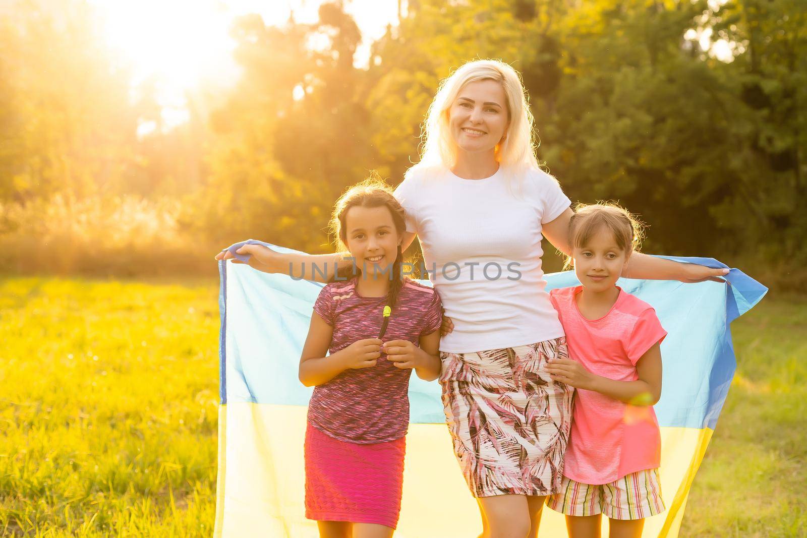 family with the flag of ukraine. Happy Independence Day of Ukraine. National Flag Day. Love for the homeland and symbols. Copy space. by Andelov13