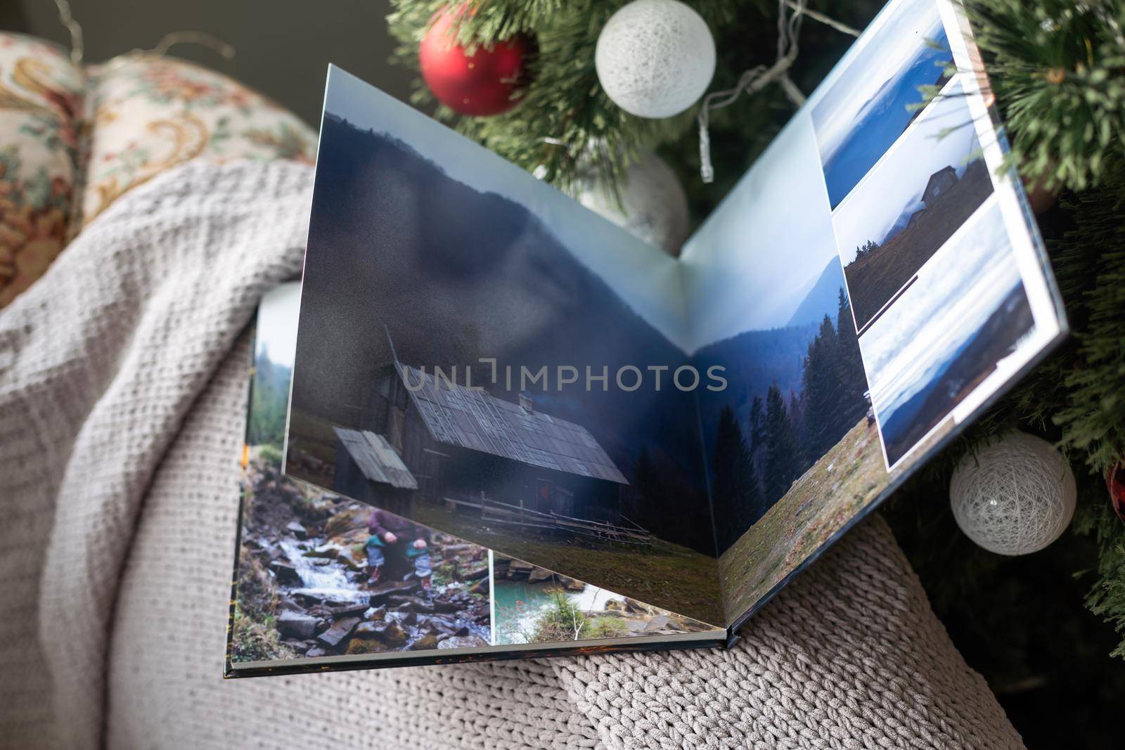 photo book about traveling near the Christmas tree.