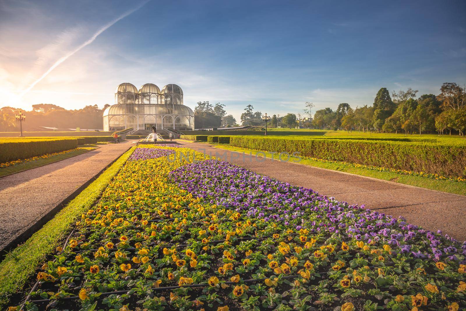 Public park around Botanical garden greenhouse in Curitiba at golden sunrise, Parana, southern Brazil