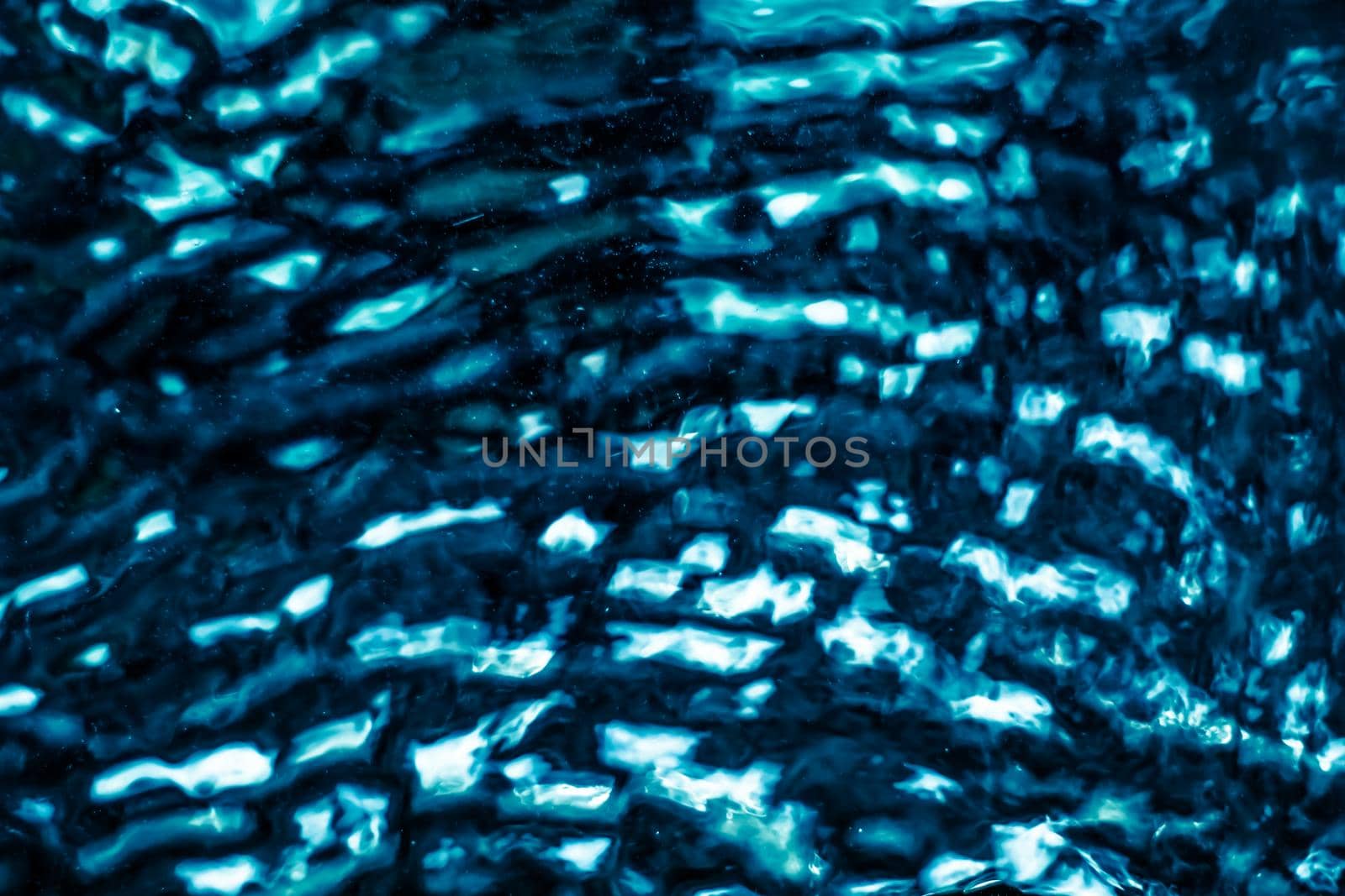 Abstract blue liquid surface as background - futuristic design and science concept. Deep blue waters