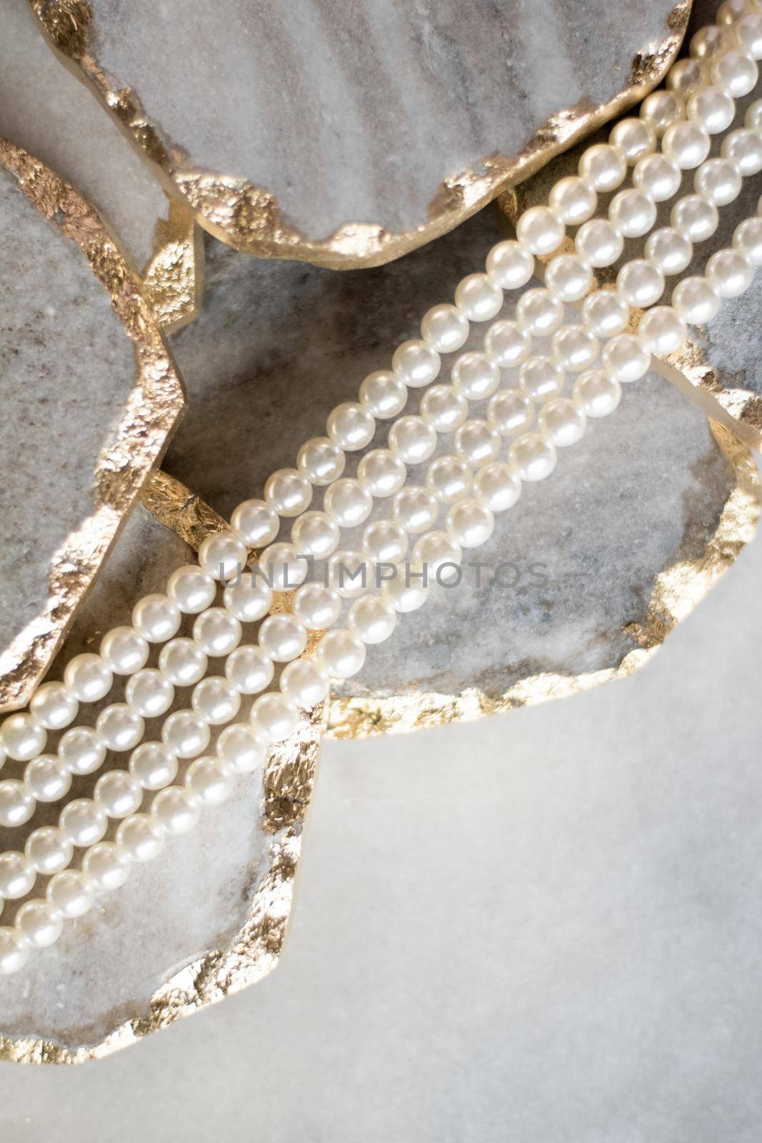 Pearl necklace on golden marble, ethical jewellery - luxury background, jewelry as a gift concept. Pearls are girl's best friends