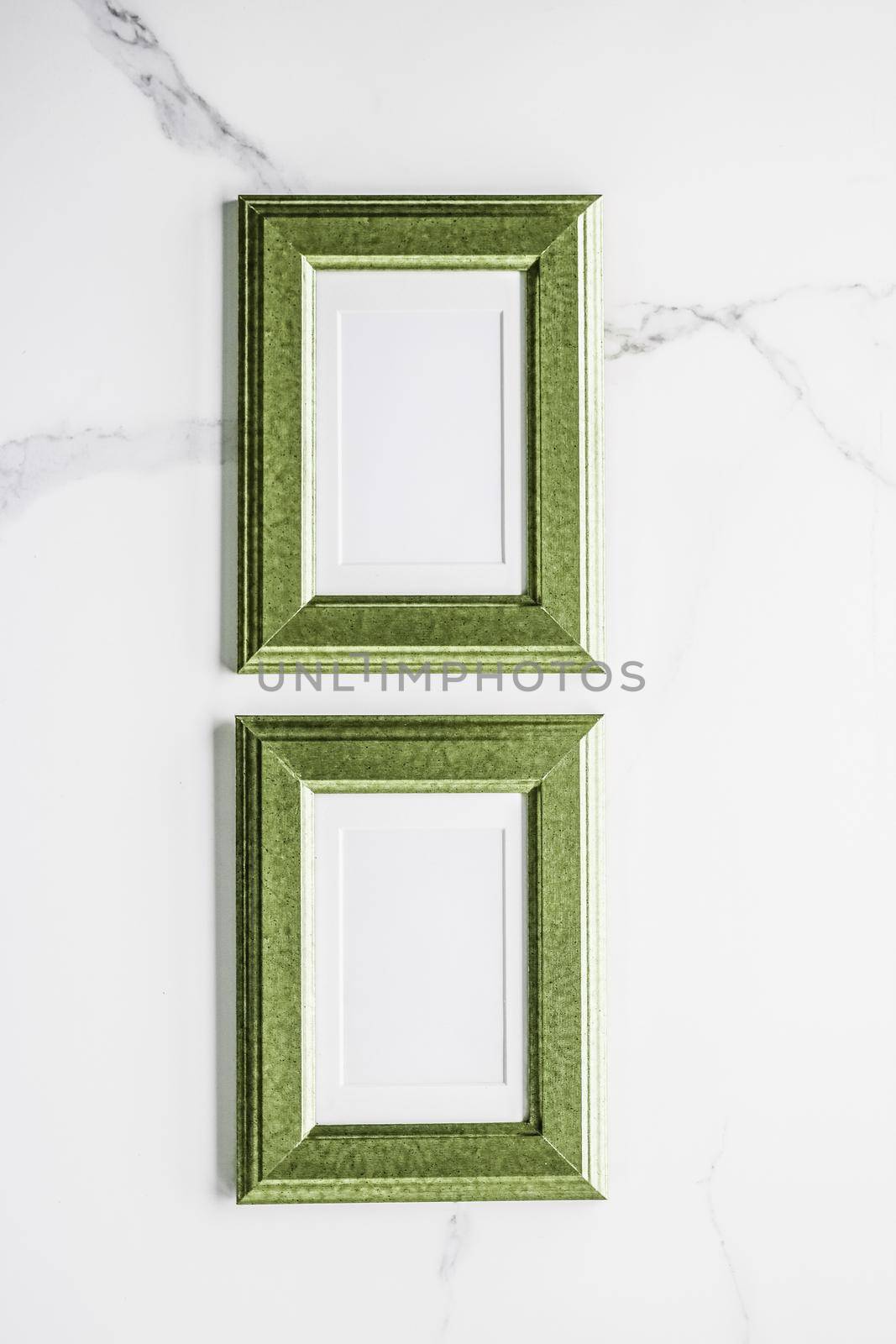 Green photo frame on marble, flatlay by Anneleven
