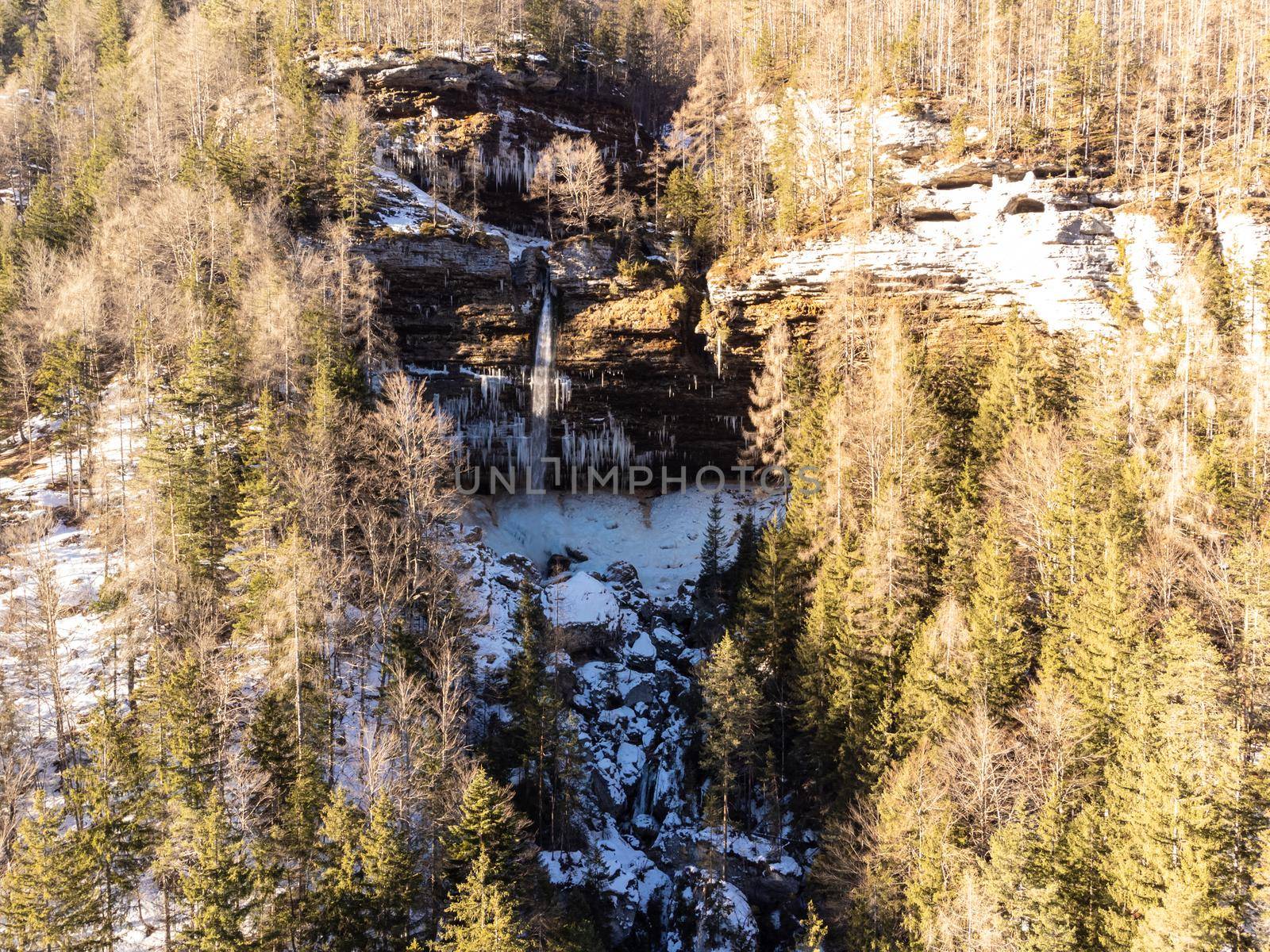 Aerial view of Pericnik slap or Pericnik Waterfall in winter time, Triglav National Park, Slovenia. Upper and lower waterfalls cascading over a rocky cliff, reachable by a picturesque walking trail. by kasto