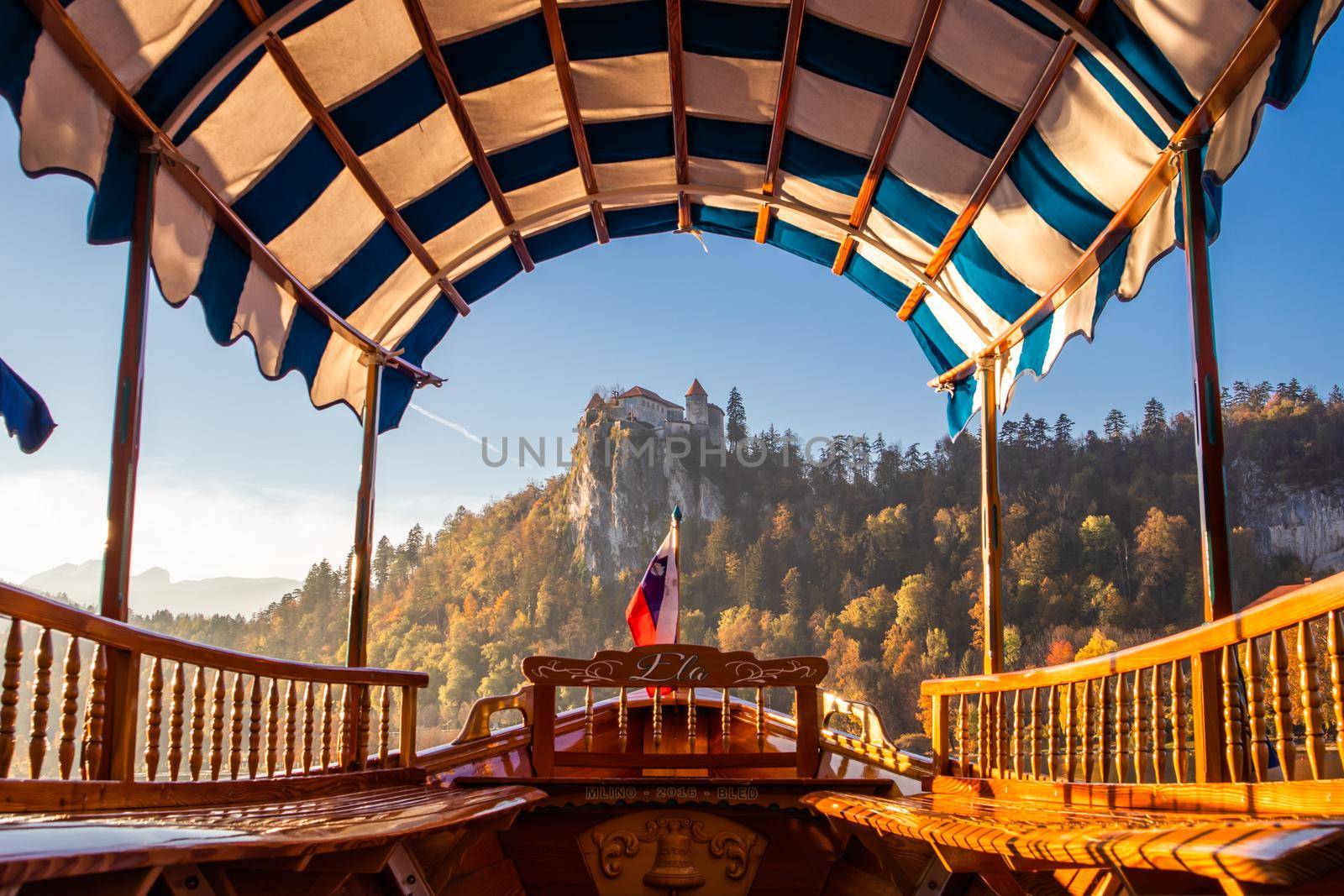 Interior of traditional pletna boat on lake Bled with old castle on the cliff, Bled, Slovenia. by kasto