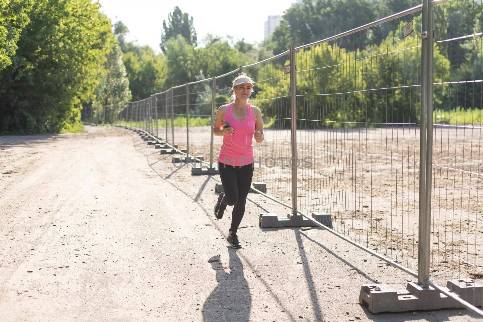 Jogging woman running in park.