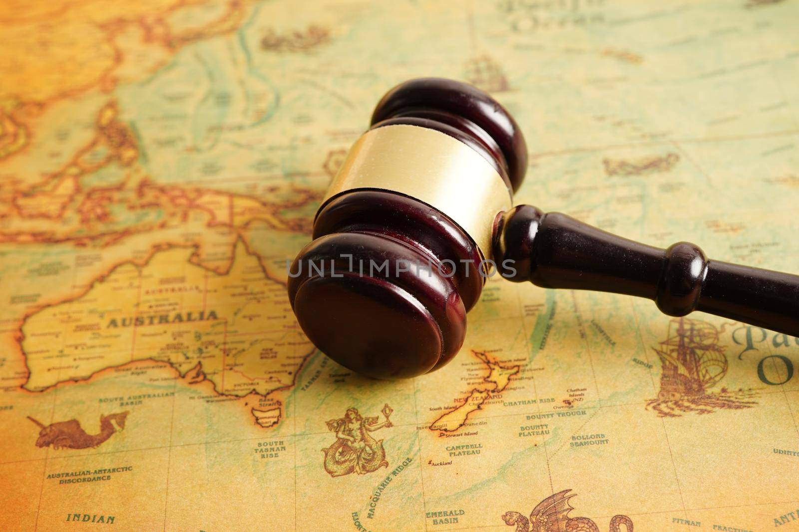 Bangkok, Thailand - December 15, 2021 Judges gavel on ancient vintage world map, international law concept.