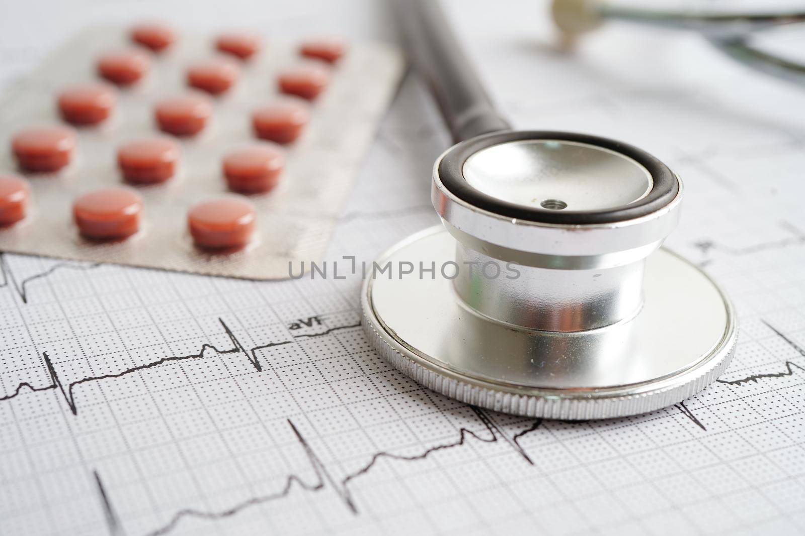 Stethoscope on electrocardiogram (ECG) with drug, heart wave, heart attack, cardiogram report.