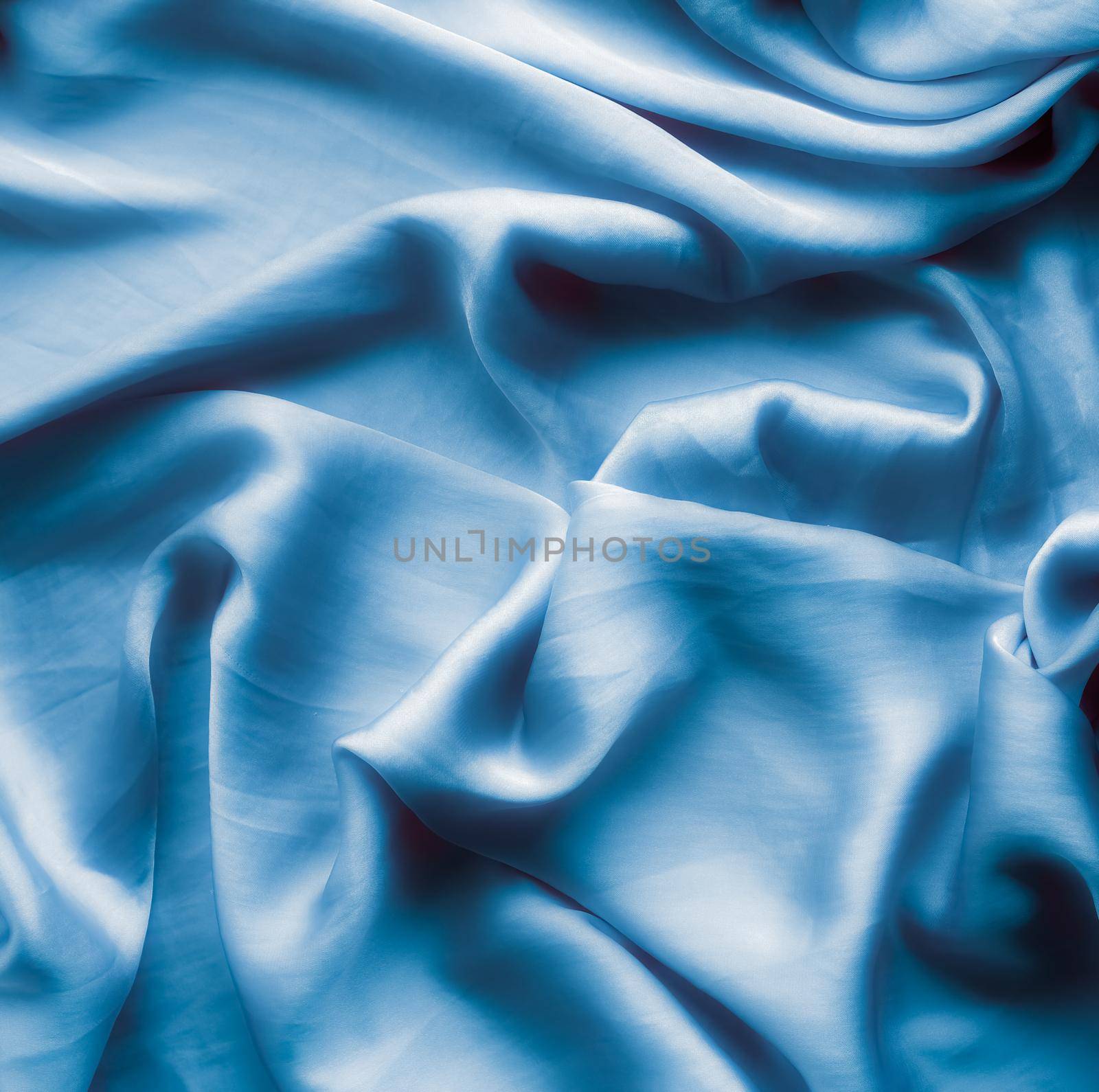 Blue soft silk waves, flatlay - elegant fabric textures, abstract backgrounds and modern pastel colours concept. Feel the touch of luxury