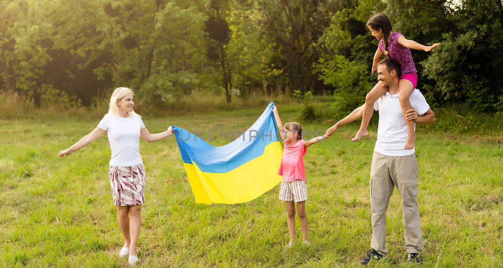 family with the flag of ukraine. Happy Independence Day of Ukraine. National Flag Day. Love for the homeland and symbols. Copy space. by Andelov13