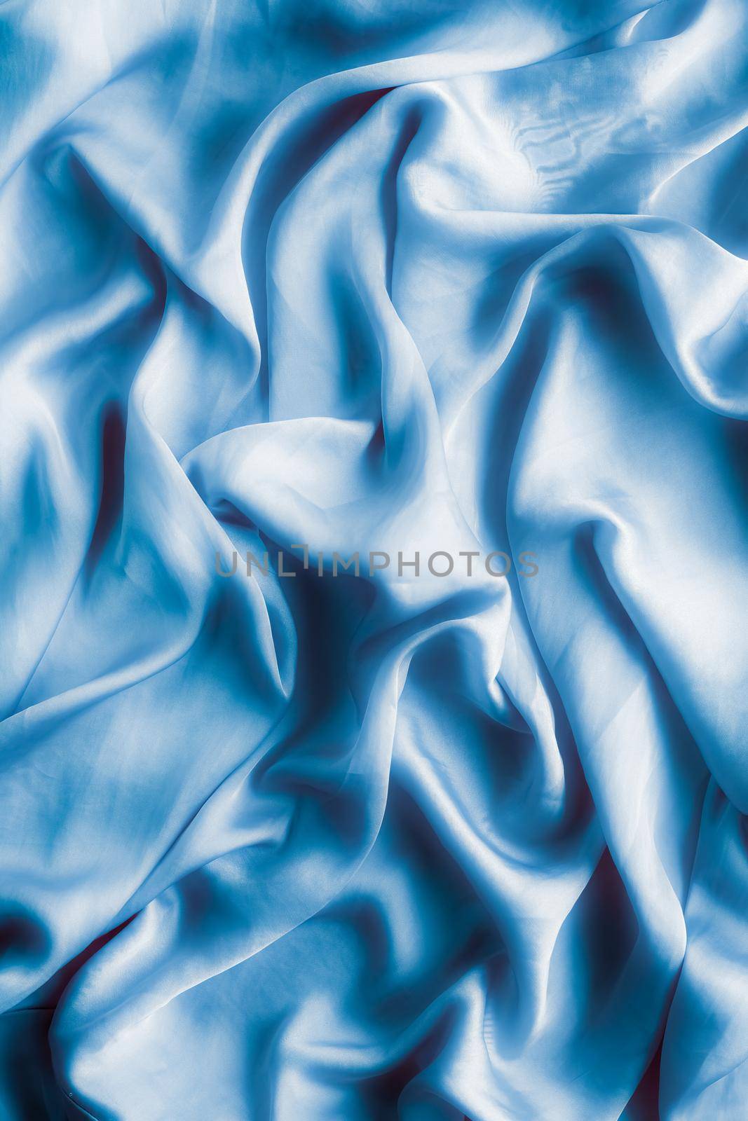 Blue soft silk waves, flatlay - elegant fabric textures, abstract backgrounds and modern pastel colours concept. Feel the touch of luxury